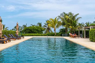 a swimming pool with chaise lounges and palm trees at Exclusive 2BR en Morros Eos with Pool & Parking in Cartagena de Indias
