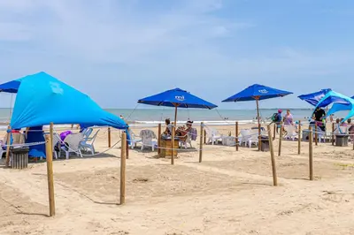 a group of blue umbrellas on a beach at Exclusive 2BR en Morros Eos with Pool & Parking in Cartagena de Indias