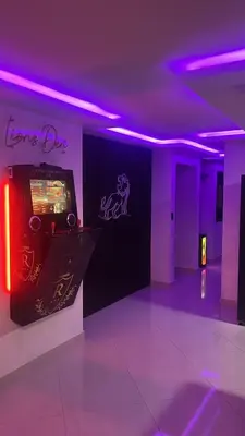 a room with a video game machine with purple lights at Modern Luxury 2BR with Private Jacuzzi in Cartagena de Indias