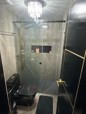 a bathroom with a black toilet and a chandelier at Modern Luxury 2BR with Private Jacuzzi in Cartagena de Indias
