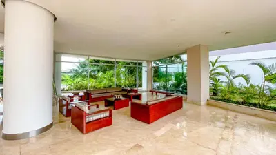 a living room with red furniture and large windows at Comodos Aptos en Morros3 con salida directa a la playa, piscina & parking in Cartagena de Indias