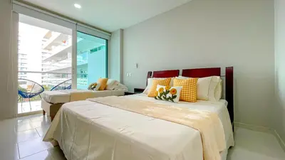 a bedroom with two beds and a large window at Comodos Aptos en Morros3 con salida directa a la playa, piscina & parking in Cartagena de Indias