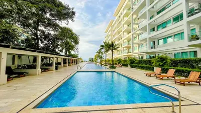a swimming pool in front of a building at Comodos Aptos en Morros3 con salida directa a la playa, piscina & parking in Cartagena de Indias