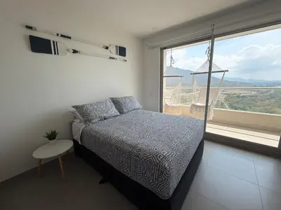 a bedroom with a bed and a large window at All new apartment in Santa Marta - NR Stays in Santa Marta
