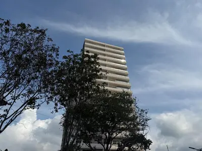 a tall white building with a tree in front of it at All new apartment in Santa Marta - NR Stays in Santa Marta