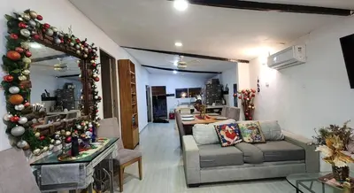 a living room with a christmas tree and a couch at Casa playa salgar in Puerto Colombia