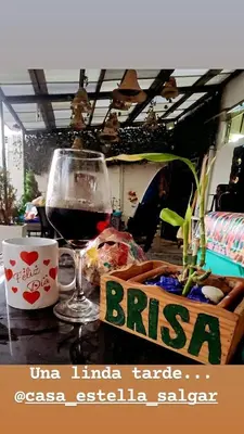 a glass of red wine sitting on a table at Casa playa salgar in Puerto Colombia