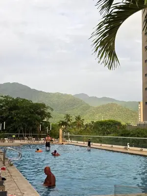 a group of people swimming in a swimming pool at Apartaestudio con hotel y playa in Santa Marta