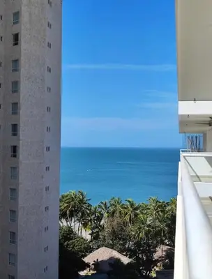 a view of the ocean from the balcony of a building at Apartaestudio con hotel y playa in Santa Marta