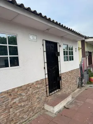 a house with a black door on the side of it at Apartamento Altos de Montecristo in Barranquilla