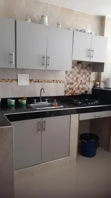 a kitchen with white cabinets and a sink at Apartamento Sector Torices in Cartagena de Indias