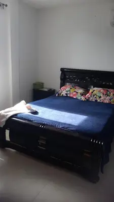 a bed in a room with a blue blanket on it at Apartamento Sector Torices in Cartagena de Indias
