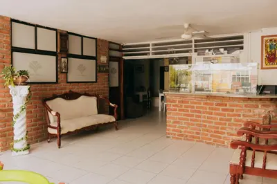a room with a chair and a brick wall at Hotel Ibatama in Cartagena de Indias