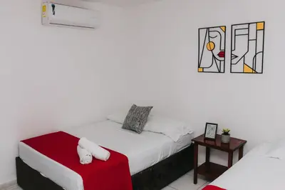 a bedroom with a bed and a stained glass window at Hotel Ibatama in Cartagena de Indias