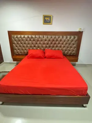 a large red bed with two red pillows on it at Acogedor espacio familiar in Cartagena de Indias