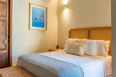 a bedroom with a large bed with white sheets at Casa Emilia - Luxury Villa in the Historic Center in Cartagena de Indias