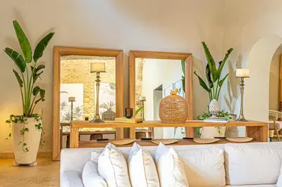 a living room with a white couch and mirrors at Casa Emilia - Luxury Villa in the Historic Center in Cartagena de Indias