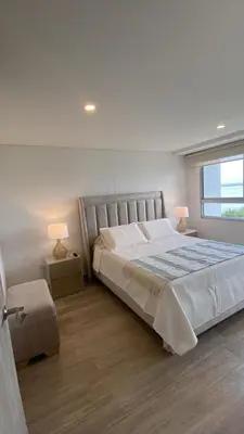 a bedroom with a large bed and a window at Apartamento en Cielo Mar Cartagena in Cartagena de Indias