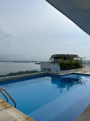 a large swimming pool with a view of the water at Apartamento en Cielo Mar Cartagena in Cartagena de Indias