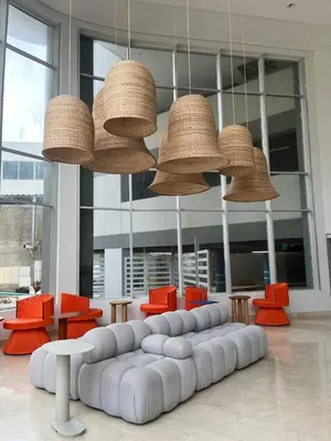 a large room with a couch and chairs and lights at Apartamento en Cielo Mar Cartagena in Cartagena de Indias