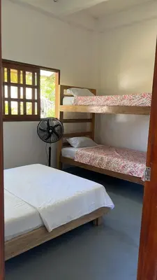 a room with three bunk beds and a window at Mi refugio in Moñitos