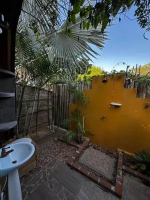 a bathroom with a sink and a yellow wall at Guacamaya Kite Lodges in Salina de Rey