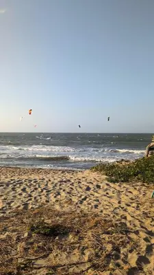 a group of kites flying over the ocean at Guacamaya Kite Lodges in Salina de Rey