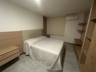 a small bedroom with a white bed in it at Apartamento cerca Malecón y CC mall plaza in Barranquilla