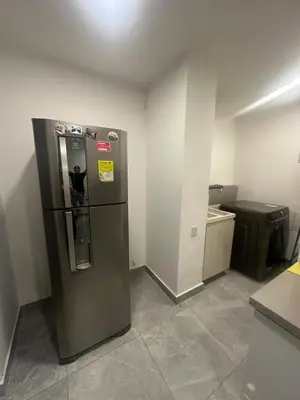a kitchen with a refrigerator in a room at Apartamento cerca Malecón y CC mall plaza in Barranquilla