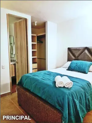 a bedroom with a bed with two towels on it at Capriella,Cartagena in Cartagena de Indias
