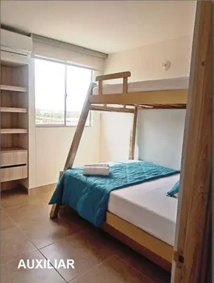 a bedroom with two bunk beds and a window at Capriella,Cartagena in Cartagena de Indias