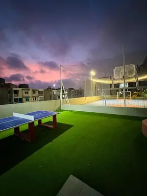 a tennis court with a net on a soccer field at cool and quiet apartment in front of the urban forest in Barranquilla