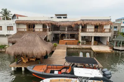 a boat on the water in front of a building at Casa Barú in Baru