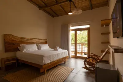a bedroom with a bed and a sliding glass door at Casa Barú in Baru