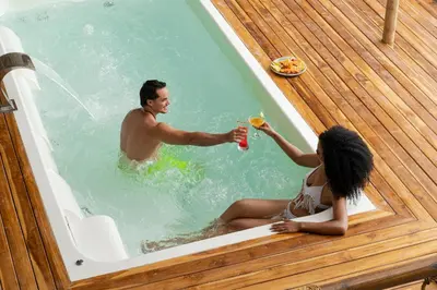 a man and a woman sitting in a bath tub at Casa Barú in Baru