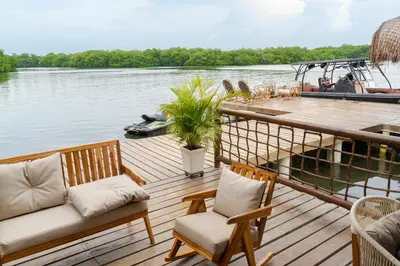a deck with two chairs and a table on a boat at Casa Barú in Baru