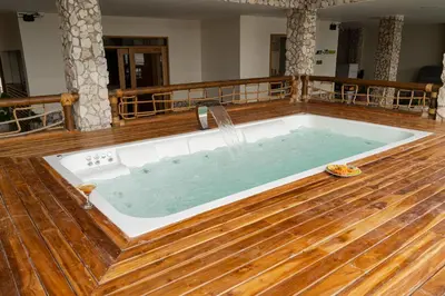 a hot tub in a room with a wooden floor at Casa Barú in Baru
