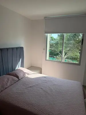 a bedroom with a bed and a window at Edificio cerca a la playa in Cartagena de Indias
