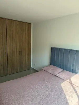 a bedroom with a bed and a cabinet at Edificio cerca a la playa in Cartagena de Indias
