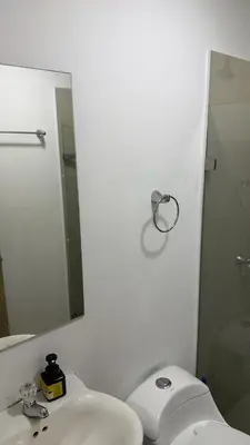 a bathroom with a sink and a mirror and a toilet at Edificio cerca a la playa in Cartagena de Indias