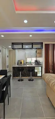 a large kitchen and living room with a table and a couch at Modern apt in Cartagena with pool and beach access in Cartagena de Indias