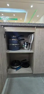 a cabinet with plates and utensils in it at Modern apt in Cartagena with pool and beach access in Cartagena de Indias