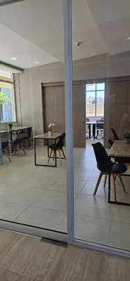a room with a table and chairs and a glass door at Modern apt in Cartagena with pool and beach access in Cartagena de Indias