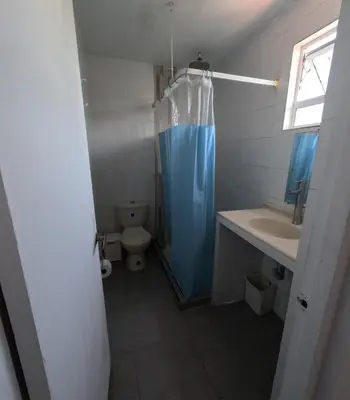 a bathroom with a toilet and a blue shower curtain at Cartagena loft apartment near historic center in Cartagena de Indias