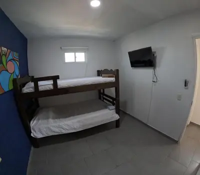 a room with two bunk beds and a television at Cartagena loft apartment near historic center in Cartagena de Indias