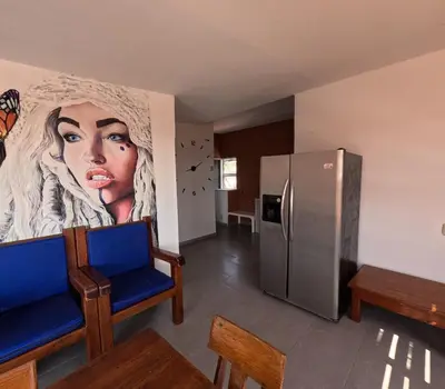 a kitchen with a large painting of a woman on the wall at Cartagena loft apartment near historic center in Cartagena de Indias