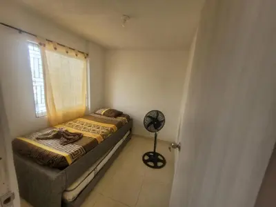 a small bedroom with a bed and a fan at Romero Cartagena in Cartagena de Indias