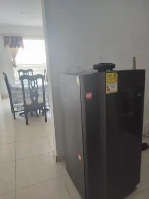 a black refrigerator in a room with a table and chairs at Romero Cartagena in Cartagena de Indias