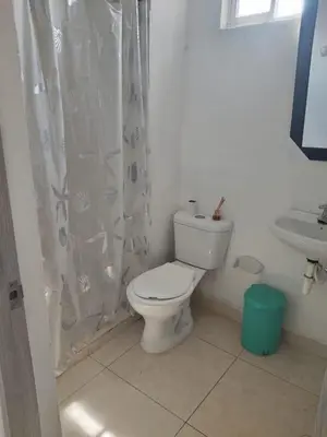 a white bathroom with a toilet and a sink at Romero Cartagena in Cartagena de Indias