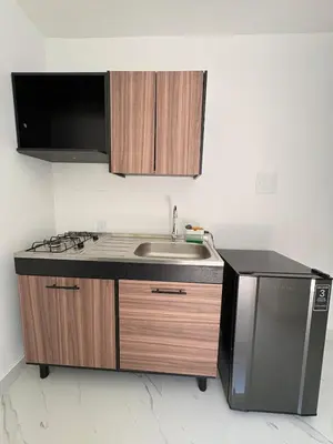 a kitchen with a sink and a microwave at Maru apartamentos #5 in Cartagena de Indias